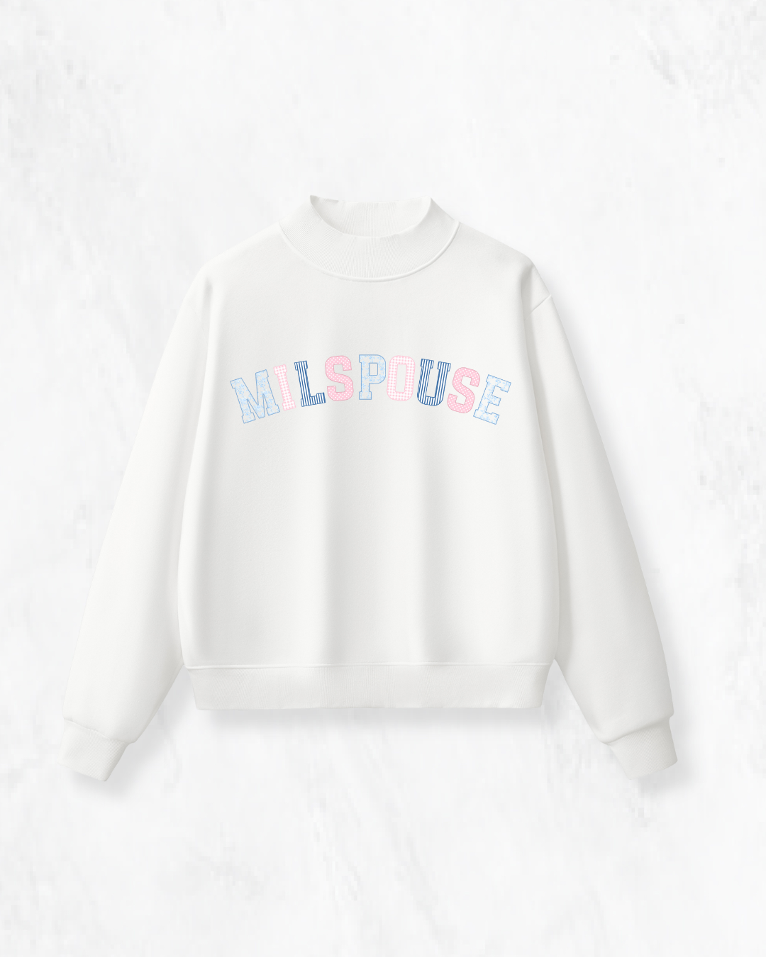 White mockneck sweatshirt with "Milspouse" in pink and blue patchwork lettering, laid flat on a white background